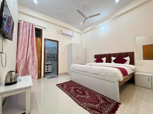 a bedroom with a large bed with purple pillows at Hotel Vikrant Inn in Lucknow