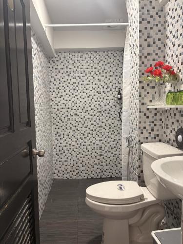 a bathroom with a white toilet and a sink at BaanPhutawanLanta resort & cafe in Ko Lanta