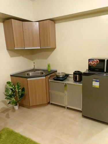 a small kitchen with a sink and a refrigerator at Stena Stays 219 in Kaybagal