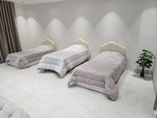 two beds with pillows on the floor in a room at Alwadi view شرفة الوادي in Nizwa