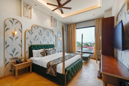 a hotel room with a bed and a large window at Hotel Marrion in Amritsar