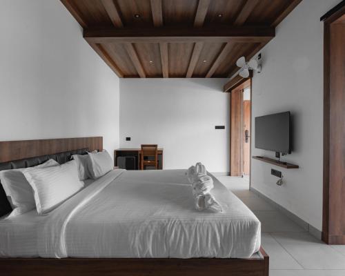 Ένα ή περισσότερα κρεβάτια σε δωμάτιο στο mayanadhi resort