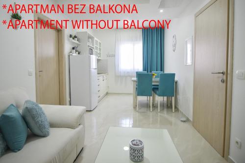 a living room with a white couch and a table at Gloria Apartments 2 in Međugorje