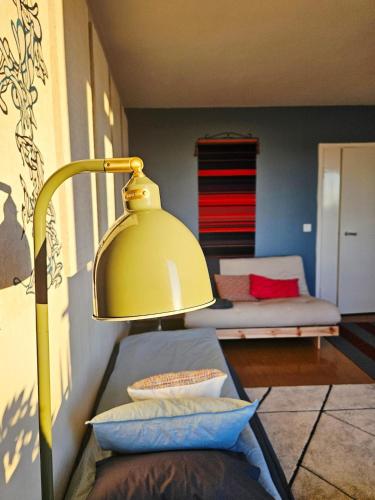 a yellow lamp in a living room with a couch at Aalto residence in Rovaniemi