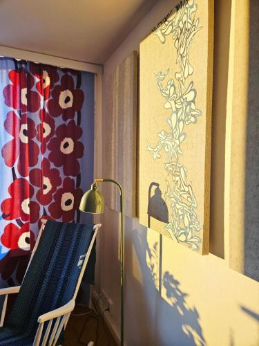 a room with a chair and a painting on the wall at Aalto residence in Rovaniemi