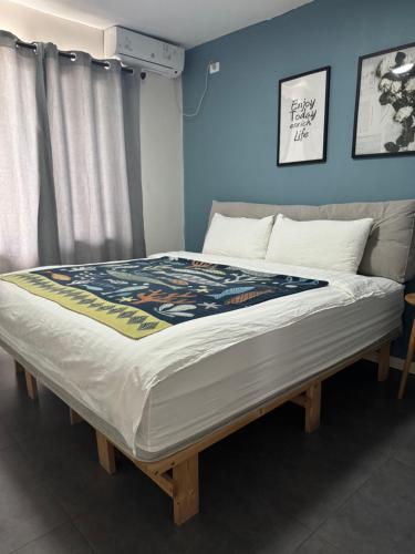 a large bed in a room with a blue wall at Mira Apartments 2BR Apartment in Nadi Free Parking & WiFi in Nadi
