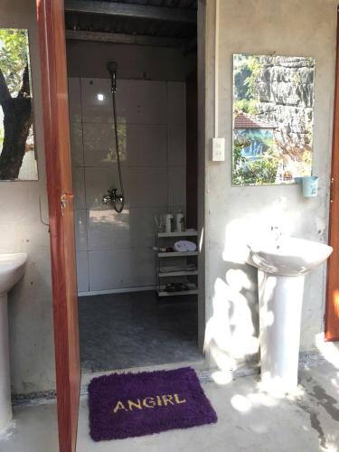 a bathroom with a sink and a toilet and a mirror at Sun Mountain Hostel in Nguyên Ngoại