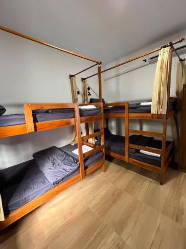 a room with three bunk beds in it at Kali Code Home in Yogyakarta