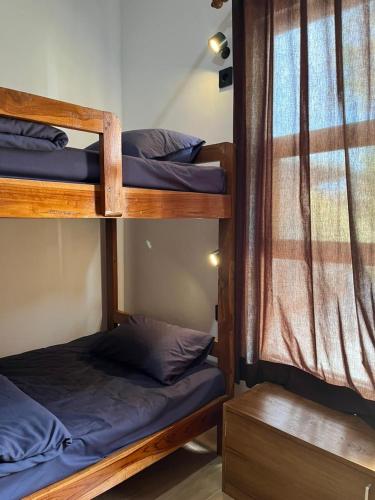 a room with two bunk beds and a window at Kali Code Home in Yogyakarta