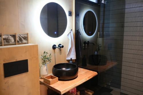 a bathroom with a black bowl on a wooden table at Jazine BeachVilla5 in Tisno