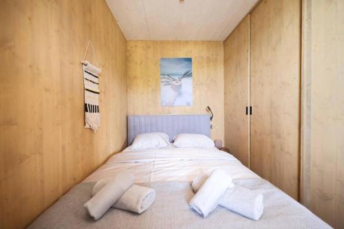 a bedroom with a bed with white pillows on it at Jazine BeachVilla5 in Tisno