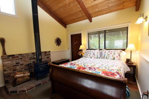 a bedroom with a bed and a wood stove at Elk Cove Inn & Spa in Elk