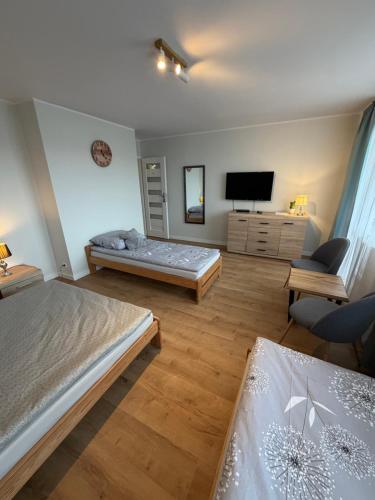 Ένα ή περισσότερα κρεβάτια σε δωμάτιο στο BlaBlaFlat Świnoujście Grunwaldzka