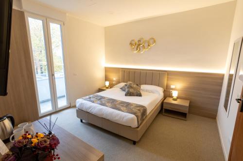 a bedroom with a bed and a large window at Hotel Richard in Agliana