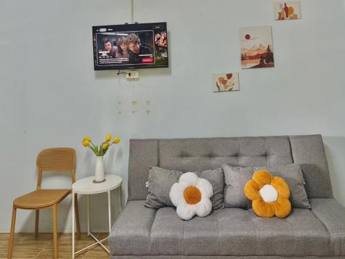 a living room with a couch with two stuffed animals at Krabi Bloom House in Ban Khlong Khamao (2)