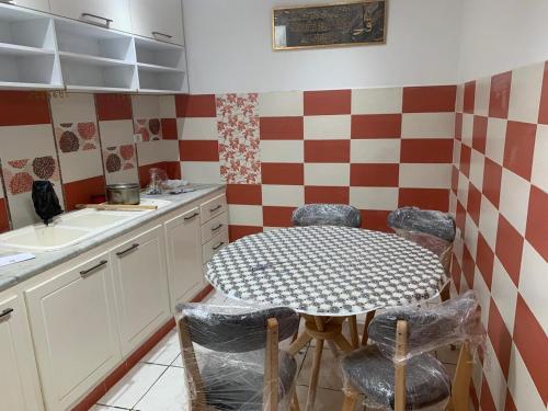 a kitchen with a table and chairs and a sink at honey moon zeinbe 3 in Hammamet