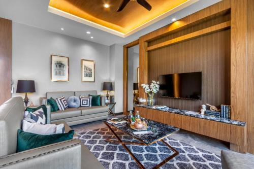 a living room with a couch and a tv at Luxury 2 Bedroom Private Pool Villa in Kamala Walk to Beach Shops and Dining in Kamala Beach
