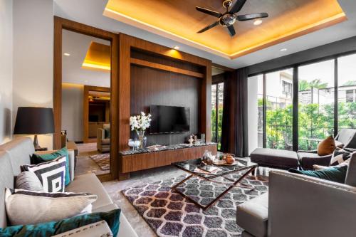a living room with a couch and a tv at Luxury 2 Bedroom Private Pool Villa in Kamala Walk to Beach Shops and Dining in Kamala Beach