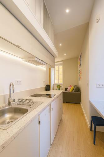a kitchen with white cabinets and a sink at Studio Masséna - Mer et Vieux Nice pour 4 personnes in Nice