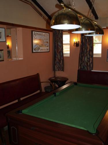 a billiard room with a green pool table at The Olde Windmill Inn in Great Cressingham