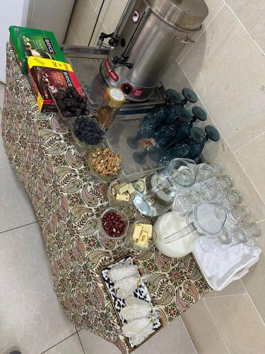 einen Tisch mit Speisen und Getränken darauf in der Unterkunft Golden Minaret Terrace old city view unreal discoun,t in Buxoro