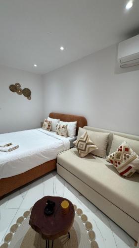 a living room with two beds and a couch at Comfort studio in 'Aïn Benian