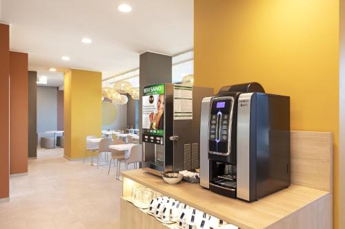 菲乌米奇诺B&B Hotel Roma Fiumicino Aeroporto Fiera 1的商店柜台上的一台电视机