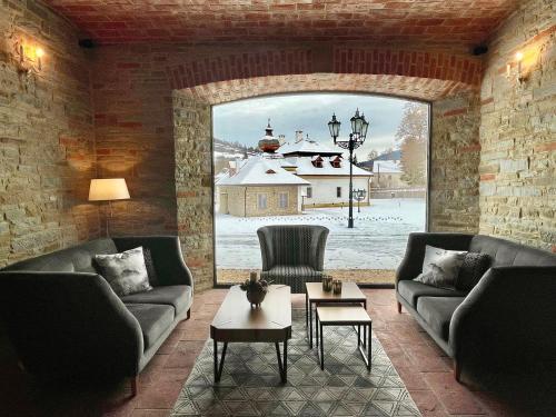 a living room with couches and a large window at Kaštieľ Kubínyi in Dolný Kubín