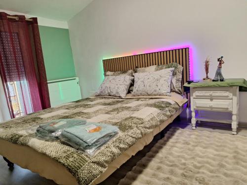 a bedroom with a bed and a night stand with a nightstand at Galamus Bonheur - Quand tu veux t'échapper de chez toi ! in Saint-Paul-de-Fenouillet