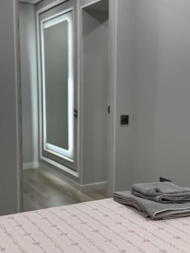 a pair of towels sitting on a bed in a room at Сатпаева, Телецентр in Taraz