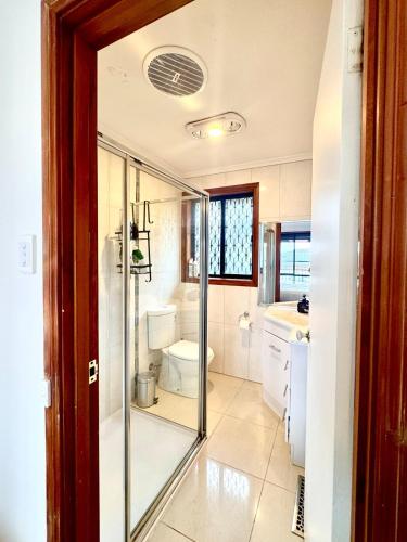 a bathroom with a shower and a toilet at Comfortable 2BR Home in Hallam in Hallam