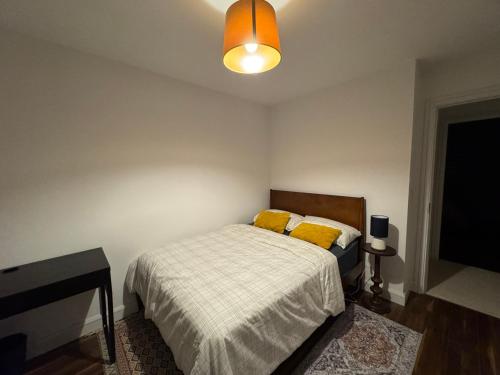 a bedroom with a bed and a flat screen tv at Cozy Double Room in a Quiet Estate Near Airport and Blanchardstown in Tyrrelstown