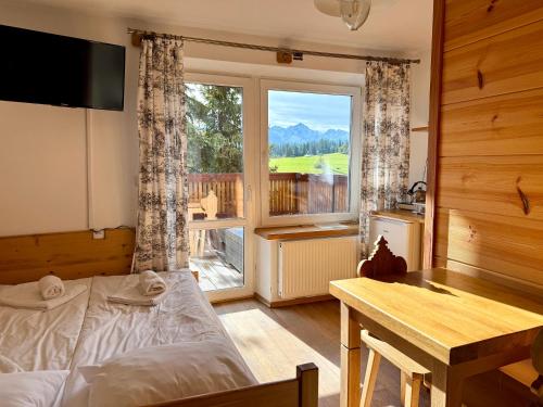 Ένα ή περισσότερα κρεβάτια σε δωμάτιο στο Willa Widokowa