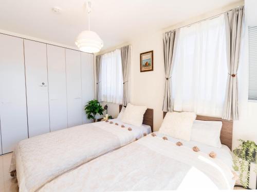 Giường trong phòng chung tại tazuraya-sakuramachi-一棟貸切-無料駐車場