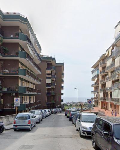 a row of cars parked in a parking lot next to buildings at Home Capri in Torre del Greco