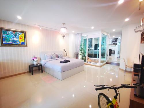 a bedroom with a bed and a bike in a room at Home Base at Krabi in Ban Khlong Chi Lat