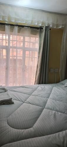 Ένα ή περισσότερα κρεβάτια σε δωμάτιο στο Rosslyn Suites