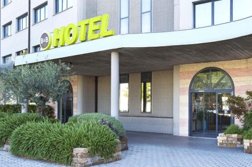 a store front of a hotel with a sign on it at B&B HOTEL Bologna in Castel Maggiore