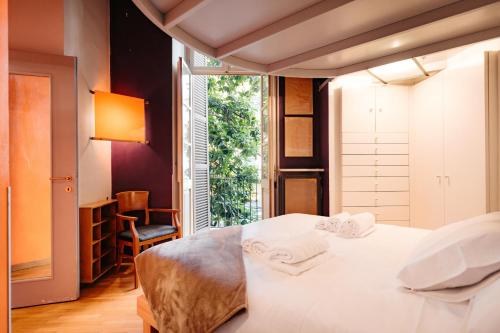 a bedroom with a white bed and a window at Carlo Alberto CHARM & TERRACE in Turin