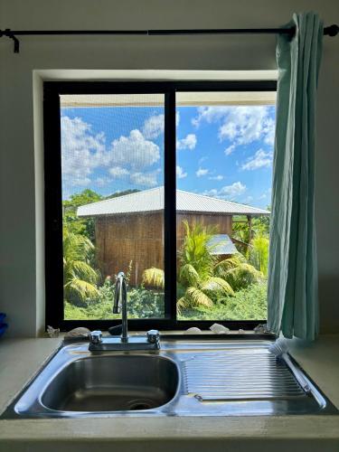 a kitchen sink in front of a window at Stella Mar Oceanfront Hotel in Popoyo