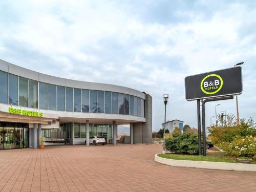 a building with a bae sign in front of it at B&B HOTEL Alba in Alba