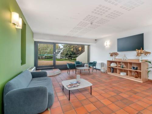 a living room with a couch and a table at B&B HOTEL Alba in Alba
