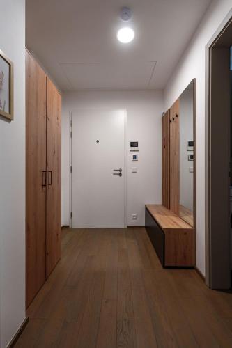 a hallway with two lockers and a bench in a room at Šantovka Residence in Olomouc