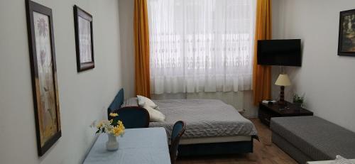 Ένα ή περισσότερα κρεβάτια σε δωμάτιο στο Cichy Zaułek 9A