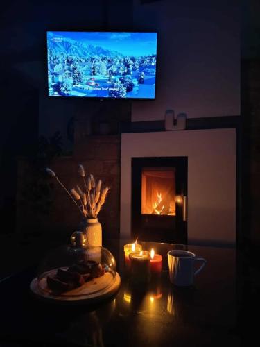 a living room with a table with a plate of food and a fireplace at Anesis House in Stroumbi