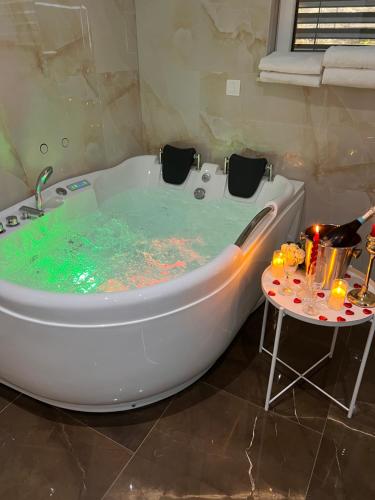 a bath tub filled with water next to a table at White House Radac Peja in Peje