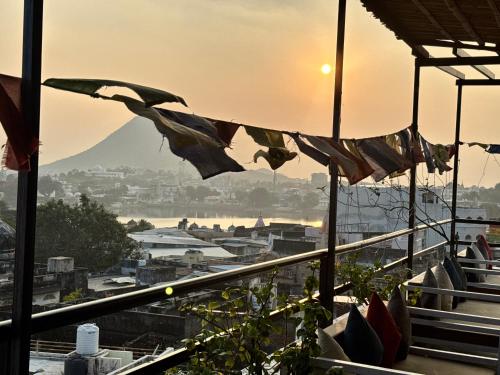 a view of a city from a balcony with flags at Pink Floyd in Pushkar