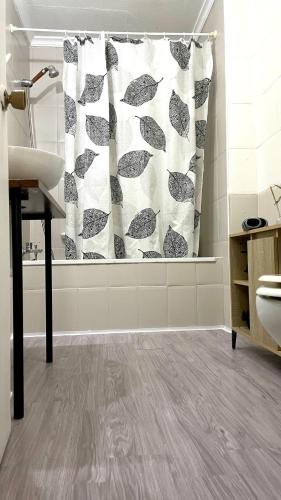 a bathroom with a shower curtain and a sink at casa rústica Ronda in Ronda