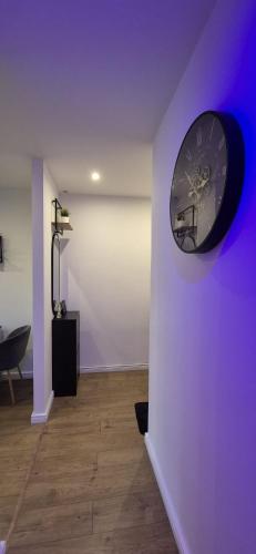 a clock on a wall in a room at Apartament Na Rynku in Bytom