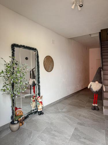 a room with a mirror and a potted plant at Casa al Castagneto in Trento